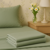 Neatly folded sage green bedsheet set displayed on matching fabric for a calm, minimalist look